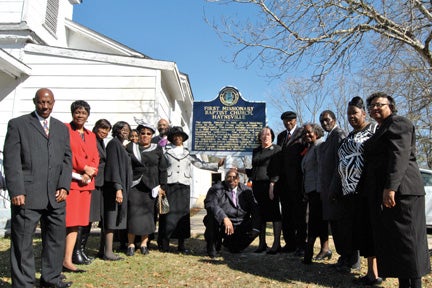Helping to show off the new historic marker at the First Missionary Baptist Church, Hayneville are, left side, front to back, Roy Managan, Dorothy Bartee, Dorothy Walker, Delois Pickney, Mattie Ruth King and Mother Celain Rudolph (100 yrs old). In back are Evangelist Orbuty Ozier and Bishop William Ozier. Right side front to back, Maggie Chaney, Rhonda Patterson, Deacon Melvin Osborne, Callie Griffin, Ed Moore King and Annie Ruth McCall Lawrence. Kneeling is Bishop. Aaron D. McCall. 