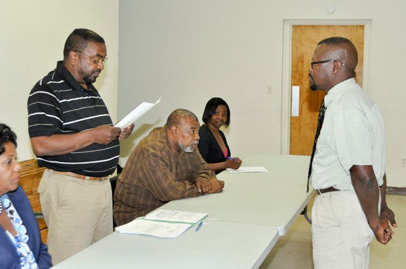 White Hall Mayor James Walker administers the oath of office to Glenn Mallard to fill the unexpired term of Council member Moses Bandy. From left looking on are Council members Audrey Peterson, Ceodis Baker and Joyce Barnfield. Mallard was appointed in a special called meeting Thursday night.