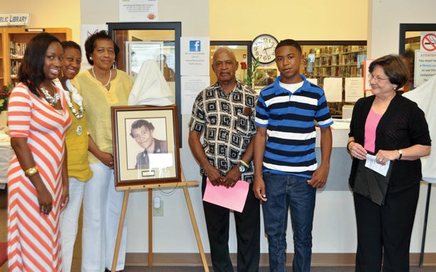 Friday marked a special day in the history of the Hayneville-Lowndes Public Library. Not only was library founder Jimmie Robinson Felder recognized on its 23rd anniversary but the library’s conference room was dedicated in honor of late board members Bernice Adams and Elizabeth Marlette with accompanying portraits. With the portrait of Adams are, from left, members of the Adams’ family, Jasmine Adams, Jemmie Jones, Fannie Adams, G’Nald Sharpe and Reginald Sharpe, as well as Library Board of Trustees Chairman Patricia Farrior. Not pictured is Mrs. Kuby Hodge of Atlanta, Ga. 