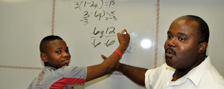 Lewis Smith, a Calhoun ninth grader gets tutoring in algebra over the summer from Aaron Casby.