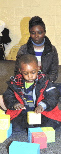 Jacqueline Wright of Hayneville watches her son Jaquan Wright. Age 3, as he builds with blocks at the Books, Balls and Blocks Event held at the Jackson Steele Community Center in White Hall on Friday, Dec. 13. Parents observed their children, filled out a questionnaire and determined if their children were on target developmentally. The event was hosted by the Lowndes County Board of Education Head Start Program and the Lowndes County Children's Policy Council.