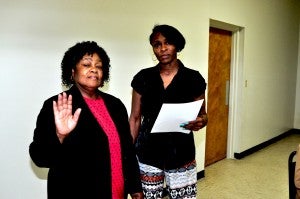 Temporary Town Clerk Felicia Perry administers the oath of office to new White Hall Council member Elizabeth Davis. Davis, who places Glenn Mallard on the council, who resigned, is a former mayor and council member for the town. 