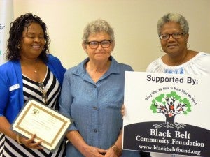 From left, Felecia Lucky, president of the Black Belt Community Foundation presents a $2,000 grant to support the Okra Festival set for Aug. 27 in Burkville, sponsored by Lowndes  Citizens United for Action (LCUFA) and the Lowndes County Commission. Receiving  the grant award from left are Barbara Evans, co-founder of the annual Okra Festival, co-founder and board member of LCUFA and Debra Harris, president of LCUFA and BBCF Lowndes County coordinator. Submitted photo. 