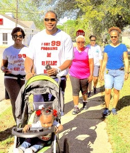 Among those walking in first countywide walk-a-thon held in Hayneville Saturday to promote a healthy lifestyle  is Dorothy Richardson of Montgomery/Fort Deposit, at right, mother of mother of Calhoun head basketball coach Derrick Powell, pictured with his daughter, Kensley Powell, age 8 months, his wife, at left, Shante Powell, who is also a nurse, at center is Bettie Rudolph of Mt. Willing, and at back is Carol Davis of Hayneville, who is Calhoun school nurse. Fred Guarino/Lowndes Signal.