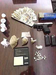 Cash, a weapon and drugs allegedly found during the arrest of a Letohatchee man at his home following an early morning shooting, Tuesday, April 1, in which he was the suspect. Submitted. 